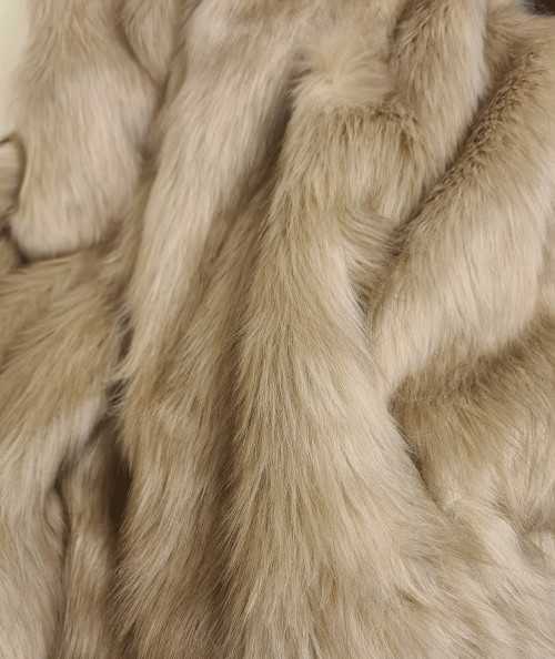 Close up image of the long haired oatmeal coloured faux fur